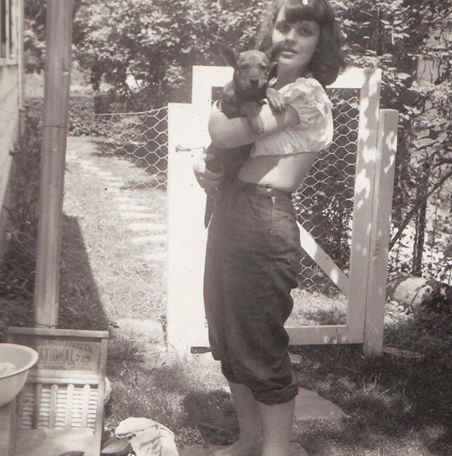 Erin as a child, barefoot with her dog